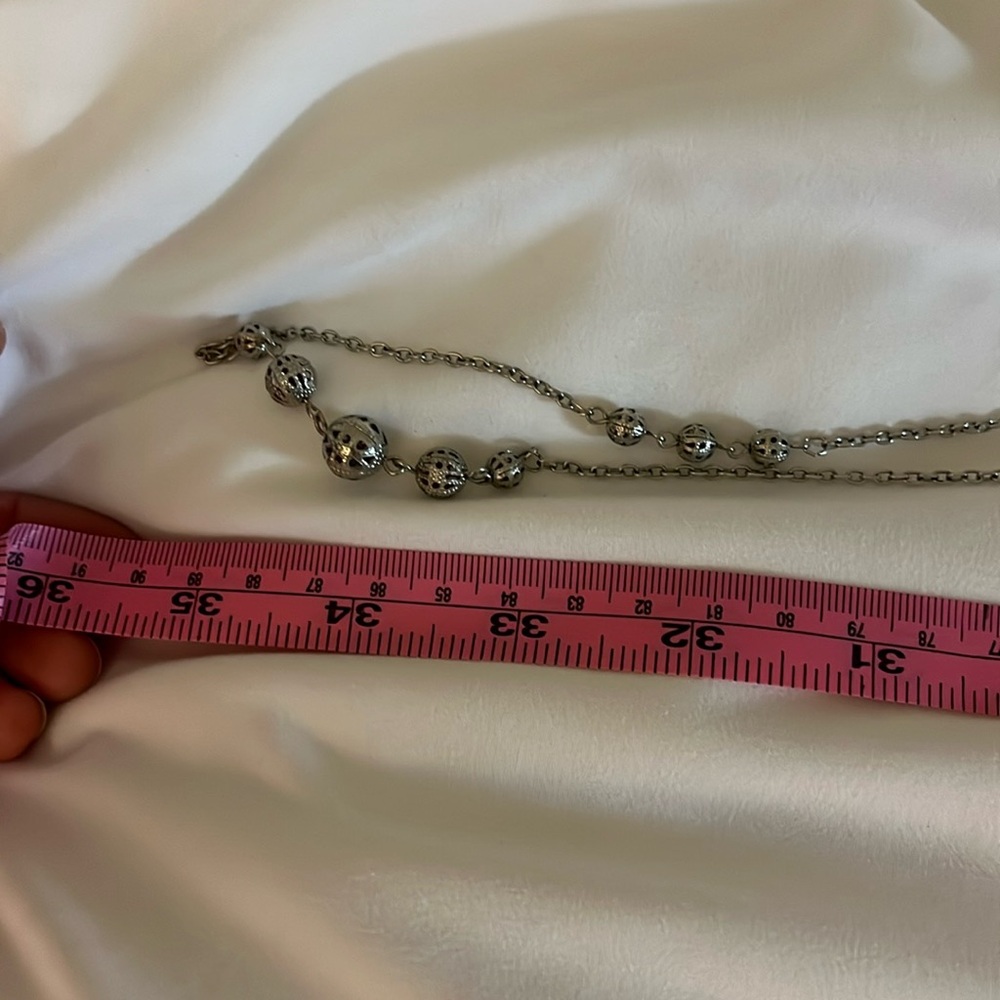Extra long looping necklace with ball details